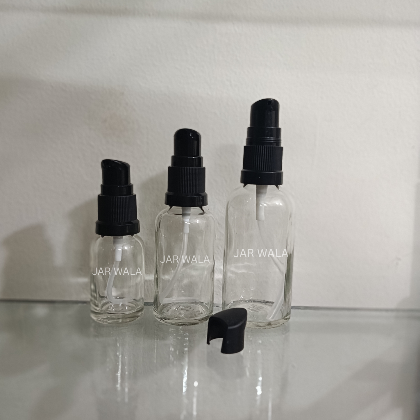 CLEAR GLASS BOTTLE WITH BLACK SERUM PUMP